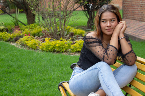 Beautiful young woman posing and modeling in a park