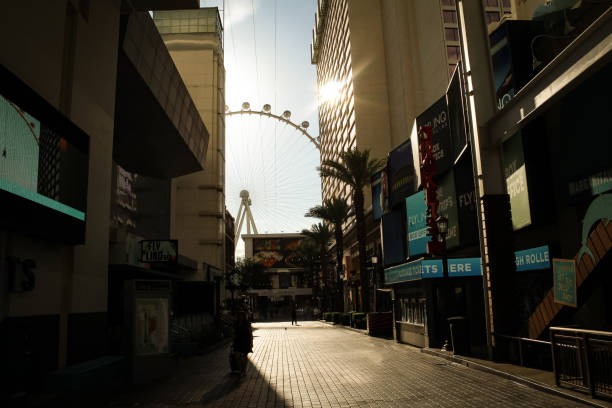 This was taken at The LINQ Promenade I. Las Vegas, NV.  The High Roller Observation Wheel can be seen while a warm glow from the sun reflects on the surrounding area.  There’s a crosswalk lined with dining and shopping
