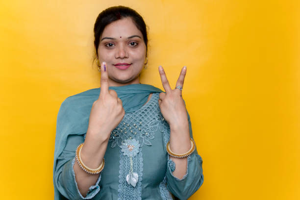 istock Happy Indian young woman showing finger after voting over isolate background. 2142392451