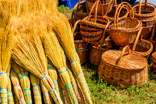 Wicker baskets and brooms for sale on street fair