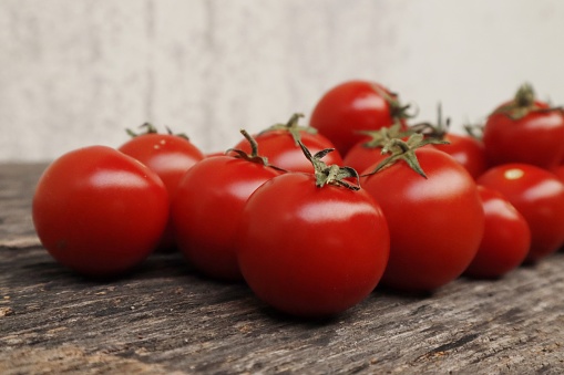 Fresh organic tomatoes on a wooden table using the Hydroponics method. Plants that nourish the skin help to brighten the skin.