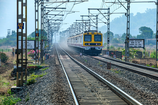 Pune, India - April 01 2024: A local suburban commuter train in the countryside  near Pune India.