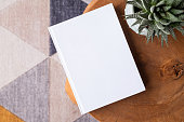 blank book mockup on coffee table with decorations and colorful rug
