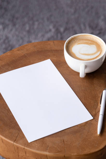 istock blank notepaper mockup on coffee table with cappuccino, pen and grey rug 2142441877