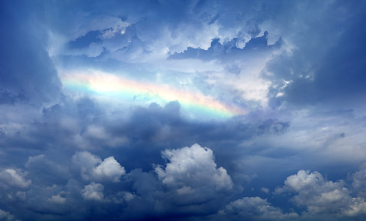 Cloudy sky and rainbow