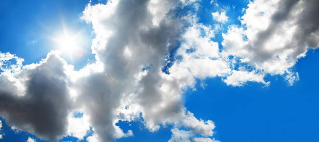 fluffy single cloud on clear blue sky background