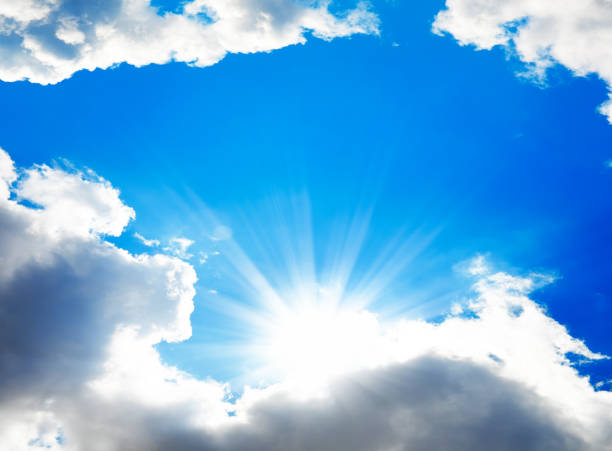 Empty Blue sky with gorgeous clouds and sun shining through