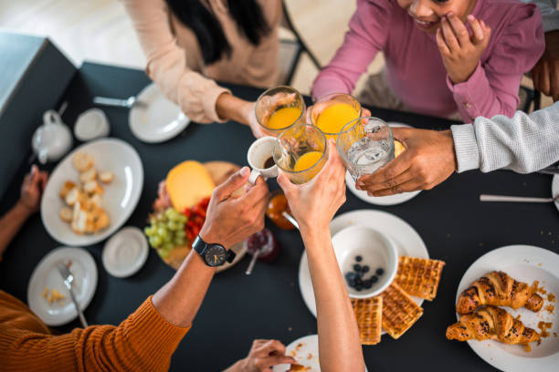 istock Diverse Family Toasting Drinks at Breakfast 2142473209