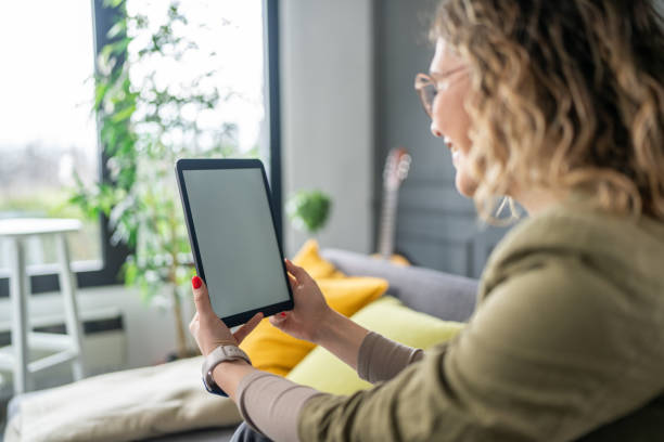istock Woman using digital tablet at home 2142499690