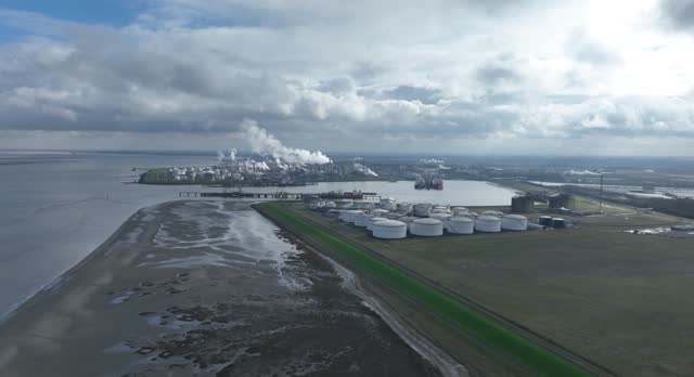 Chemical industry at terneuzen. DOW chemical park and petrochemical storage containers. Smokestacks and heay industry. Birds eye aerial drone view.