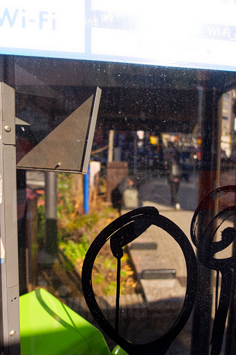 Cityscape with close-up of dirty and sprayed phone booth at Japanese City of Tokyo on a sunny winter day. Photo taken January 27th, 2024, Tokyo, Japan.