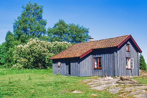 Lurö, Sweden-Julne, 2021: Old wooden cottage on a meadow in the summer
