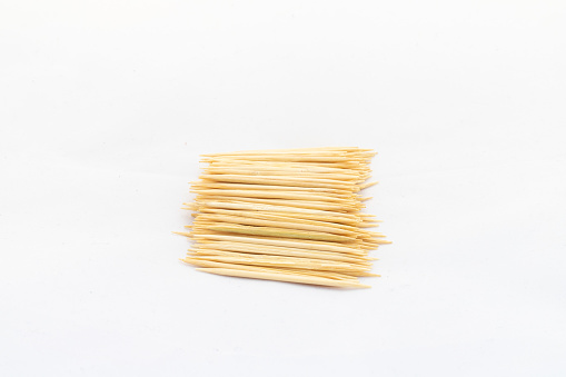 Bamboo toothpicks on white isolated background