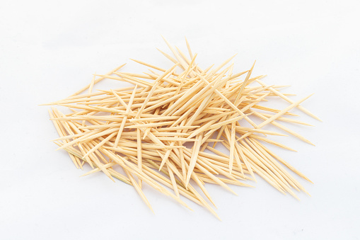 A toothpick is a small thin stick of wood with pointed ends to insert between teeth to remove detritus, usually after a meal
