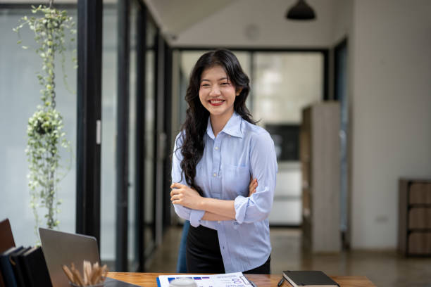 istock standing with arms crossed at desk 2142542898