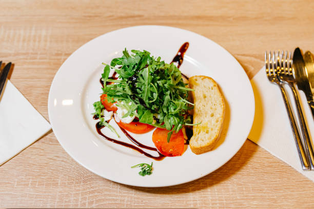 istock Fresh Arugula and Tomato Salad with Balsamic Drizzle 2142543414