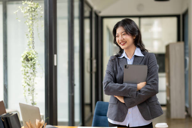 istock confident businesswoman standing with tablet 2142553827