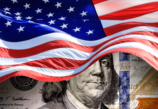 istock American flag and American one hundred dollar bill 2142565767