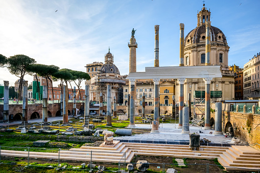 A beautiful late afternoon scene of Trajan's Forum, part of the Imperial Forums of Rome, in the historic heart of the Eternal City. In the background the baroque church of the Santissimo Nome di Maria al Foro and the Trajan Column, while in the foreground the remains of the majestic colonnade of the Basilica Ulpia, built in honor of the Emperor Trajan's family. The Roman Forum, one of the largest archaeological areas in the world, represented the political, legal, religious and economic center of the city of Rome, as well as the nerve center of the entire Roman civilization. In 1980 the historic center of Rome was declared a World Heritage Site by Unesco. Image in high definition quality.