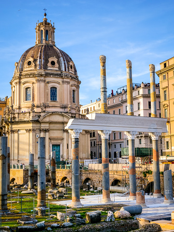 A beautiful late afternoon scene of Trajan's Forum, part of the Imperial Forums of Rome, in the historic heart of the Eternal City. In the background the baroque church of the Santissimo Nome di Maria al Foro, while in the foreground the remains of the majestic colonnade of the Basilica Ulpia, built in honor of the Emperor Trajan's family. The Roman Forum, one of the largest archaeological areas in the world, represented the political, legal, religious and economic center of the city of Rome, as well as the nerve center of the entire Roman civilization. In 1980 the historic center of Rome was declared a World Heritage Site by Unesco. Image in original 4:3 ratio and high definition quality.