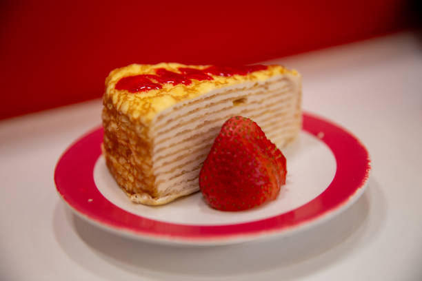 Close-up of a chef holding waffle with fruit at commercial kitchen