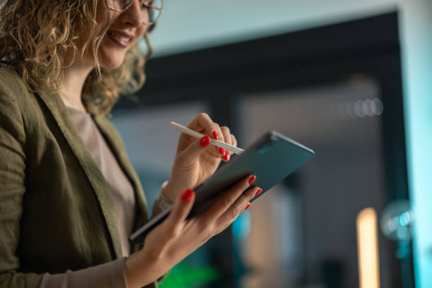 istock Young businesswoman using digital tablet in the office 2142619330
