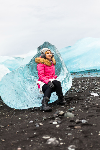 A women posing in Jokulsarlon is a glacial lagoon or better known as Iceberg Lagoon which located in Vatnajokull National Park Iceland