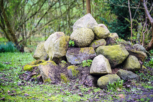 Ecological stone pile, a natural paradise in the garden, small caves and niches offer hiding places, protection and habitat for many animals, copy space, selected focus, narrow depth of field
