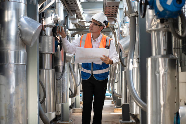 istock Engineers are inspecting a large building or industrial facility's cooling system for the air conditioning. 2142638134