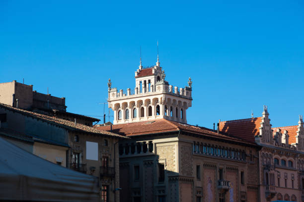 Traditional buildings with ornate facades under the clear blue sky in vic, spain