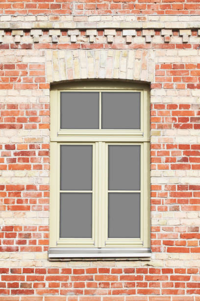 istock Brick wall window. Old architecture. Grunge brick wall texture. Rustic building renovated. 2142716866