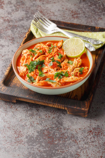 istock Crock Pot Salsa Chicken with taco seasoned pulled chicken breasts and tomato salsa close-up in a bowl. Vertical 2142767230