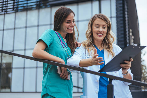 istock Two female surgeons discuss the cases for the day. 2142773403