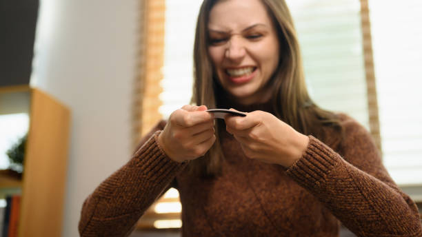 istock Upset young woman breaking her credit card. Financial problems concept 2142791601