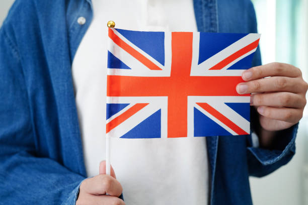istock Learning English, Asian teenage student holding flag for language program education. 2142792143