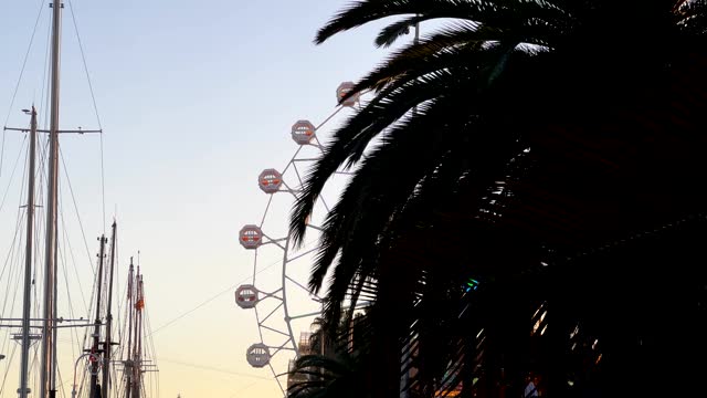Ferris wheel in park over sunny blue sky