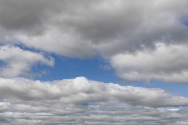 Expanse of blue sky, interspersed with puffy clouds that fade gently into the distance, creating an ideal setting for artistic and design projects