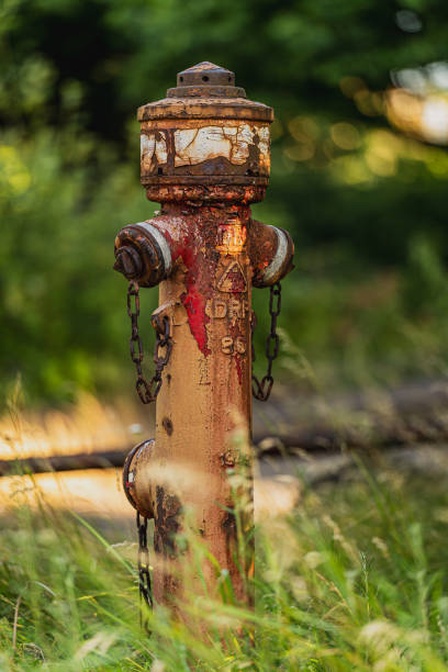 A rusted water hydrant on an abandoned building.