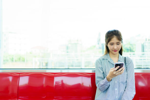 istock Businesswoman using smartphone while traveling on a train. 2142968701