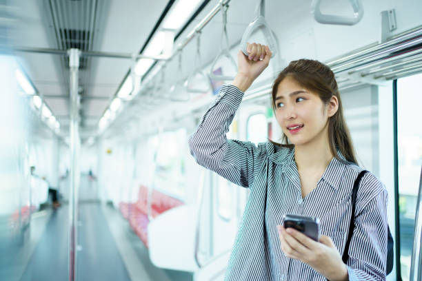 istock Businesswoman using smartphone while traveling on a train. 2142969217