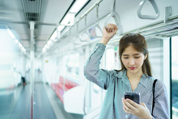 istock Businesswoman using smartphone while traveling on a train. 2142969218