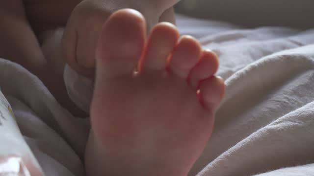 Little girl's foot, wiggling her toes.