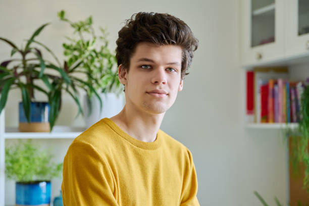 istock Portrait of young handsome guy looking at camera, in home interior 2143032230