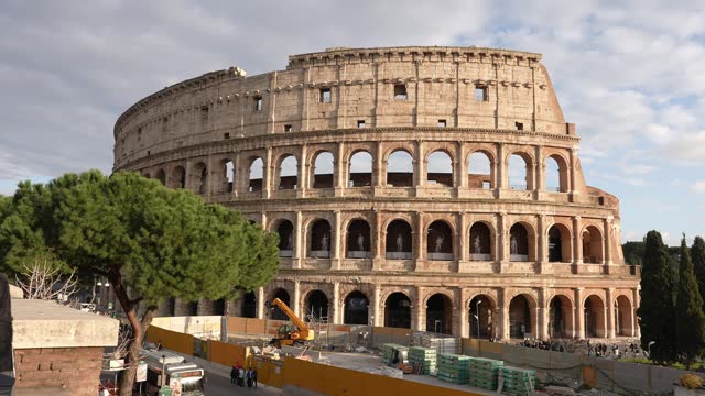 Tourists explore Colosseum in Rome, Italy. Ancient Roman Colosseum is one of main tourist attractions in Europe.