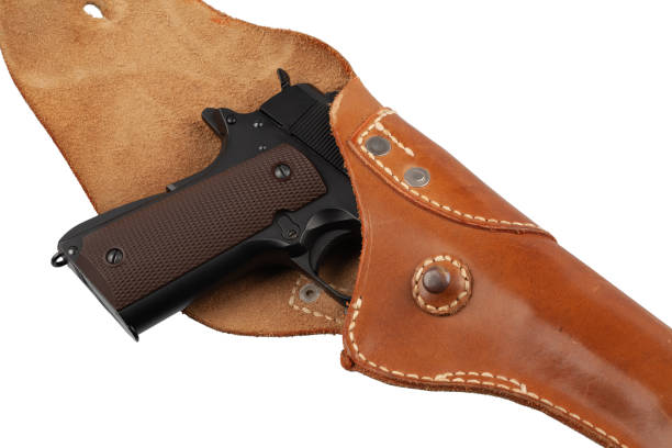 Automatic Pistol, Caliber .45 in holster Automatic Pistol, Caliber .45 in holster isolated on white background forty five caliber handgun stock pictures, royalty-free photos & images