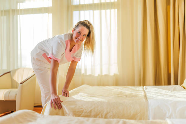 istock Hotel maid  making bed in a room 2143075304