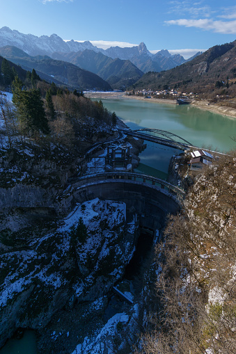 Alpine winter landscape with reservoir lake and dam surrounded by mountains, Barcis, Friuli-Venezia Giulia, Italy