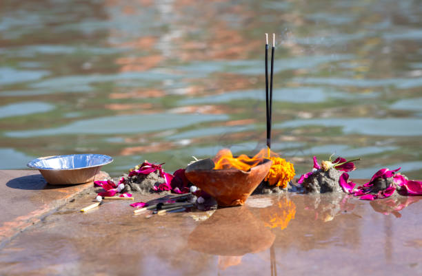 istock holy offerings by devotee at religious river shore at morning from flat angle 2143082536