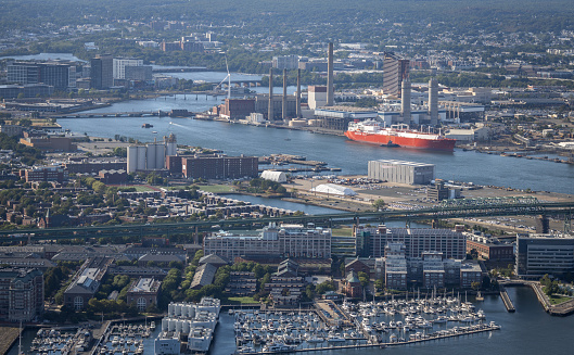 An aerial view of buildings and a Liquid Natural Gas docked in Boston