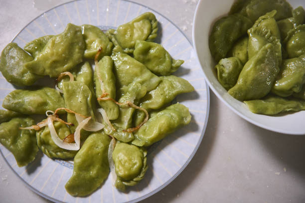 istock Plates with freshly prepared dumplings with mashed potatoes, on a marble table background. Culinary. Homemade cooking. Food background. Ukrainian or Italian traditional meal. View from above 2143084635